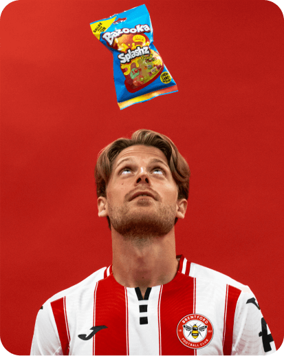 3 footballers enjoying bags of sweets